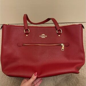 Dark red coach bag with gold accents. Gorgeous and classy.